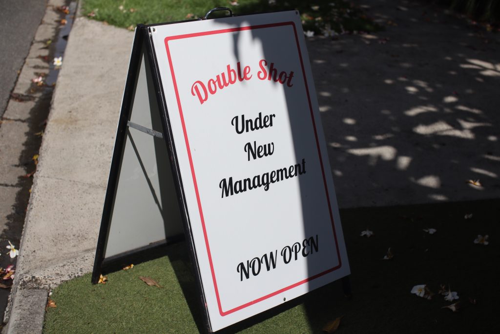 Double Shot Panini Cafe sign says Under New Management. Now open.